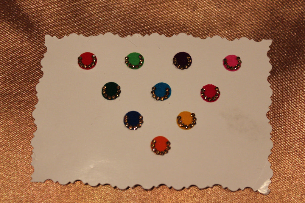 Bindis are coloured dots worn on the centre of a woman's forehead they come in various designs and shapes.   A card of bindis come in different colours and are reusable. To reuse the adhesive after it is worn off, we recommend the use of eyelash glue for application. 