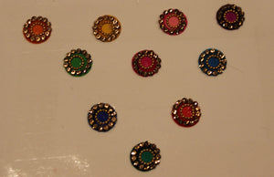 Bindis are coloured dots worn on the centre of a woman's forehead they come in various designs and shapes.   A card of bindis come in different colours and are reusable. To reuse the adhesive after it is worn off, we recommend the use of eyelash glue for application. 